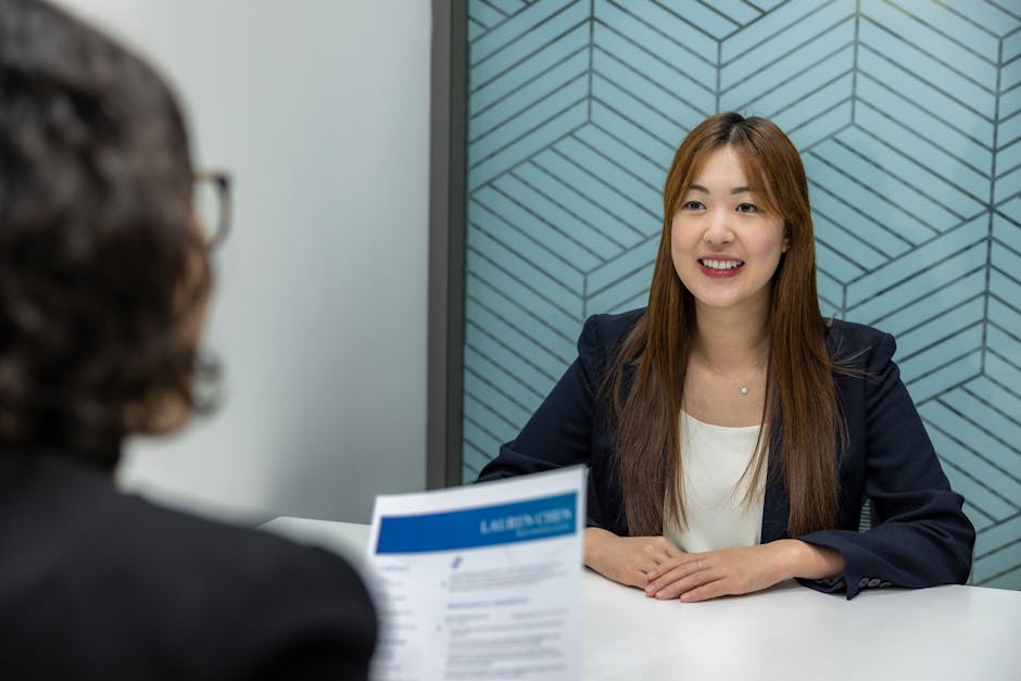 Young woman in a business meeting with an interviewer, showcasing confidence and professionalism