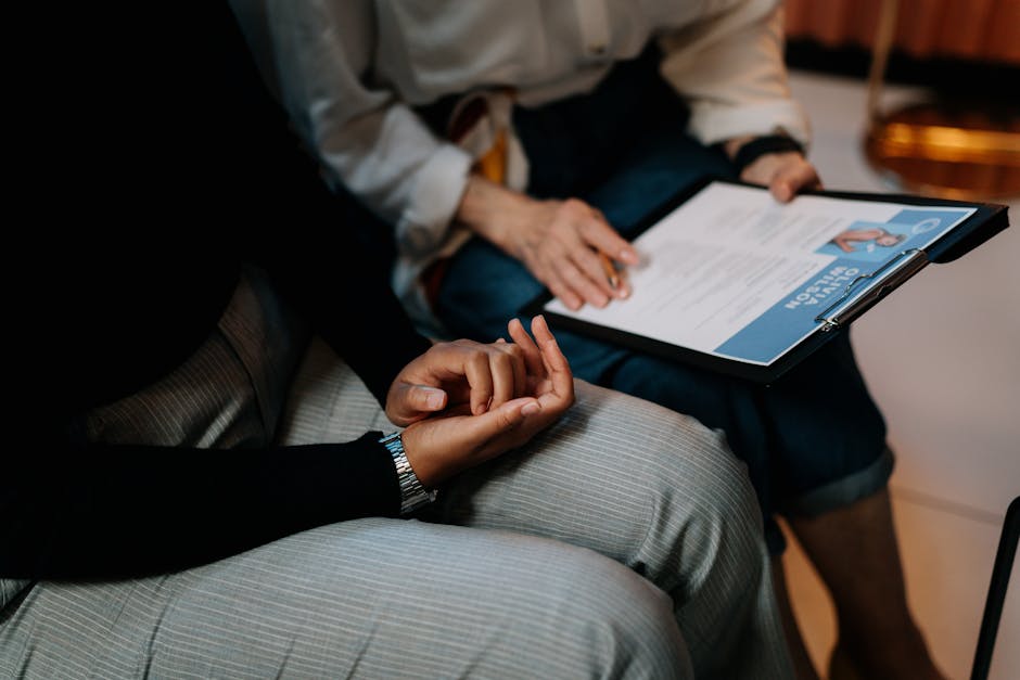 Two professionals reviewing a resume in an office setting, focused on teamwork