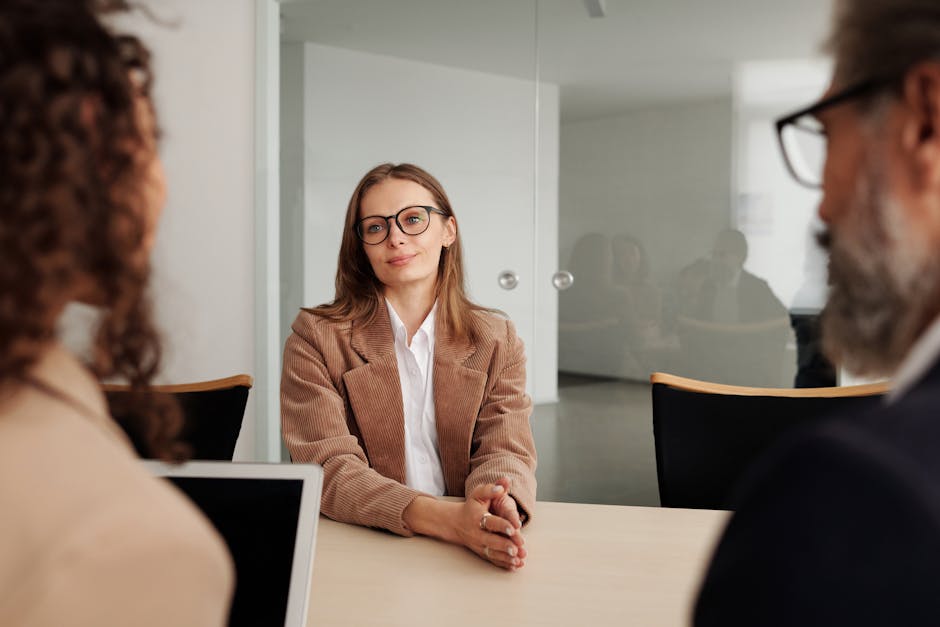 Young woman attending a job interview in a modern office, showcasing confidence and professionalism