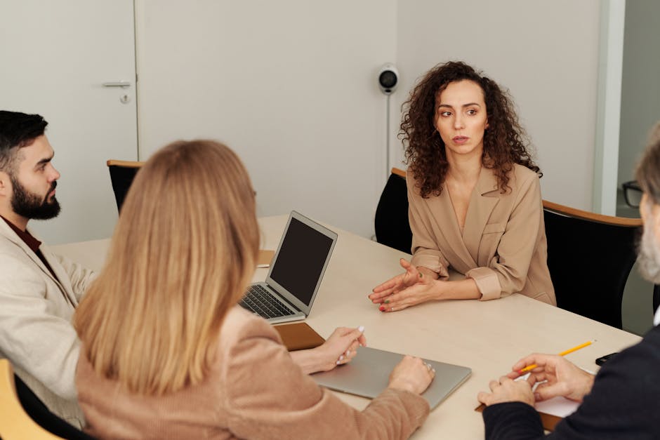 A diverse team of professionals engaged in a business meeting in a modern office setting